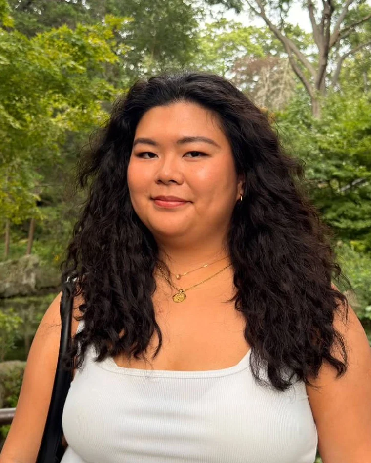Megan Cheng smiling outdoors in a leafy Toronto park